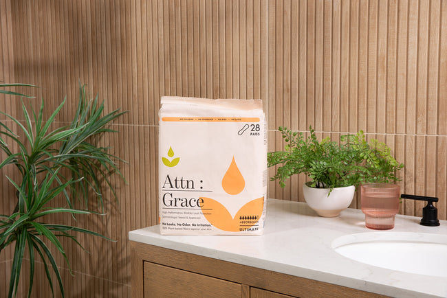 Attn: Grace incontinence pad pack on a bathroom counter