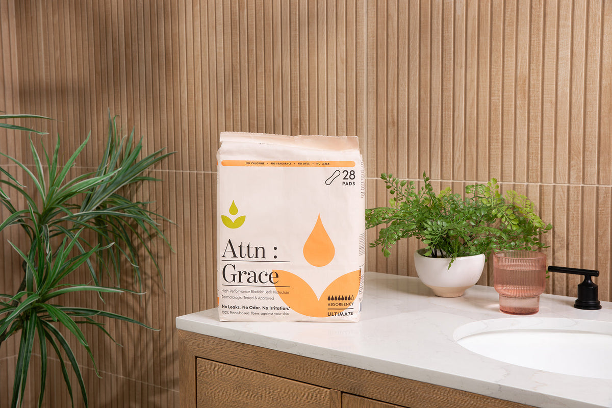 Attn: Grace incontinence pad pack on a bathroom counter