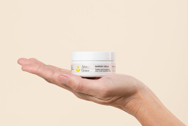 close up of barrier cream in the palm of a woman's hand