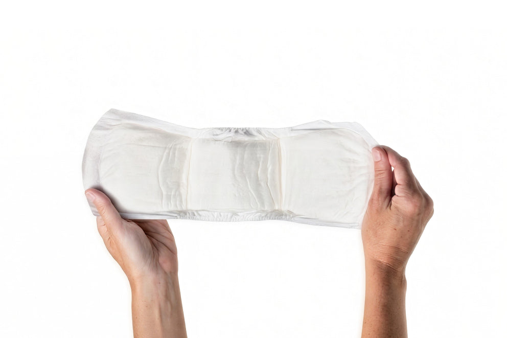 Woman's hands holding an Attn: Grace Ultimate Pad