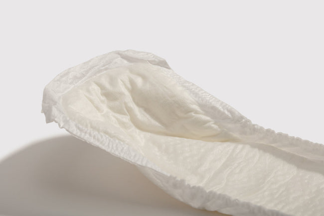 Close up shot of incontinence pad on grey background