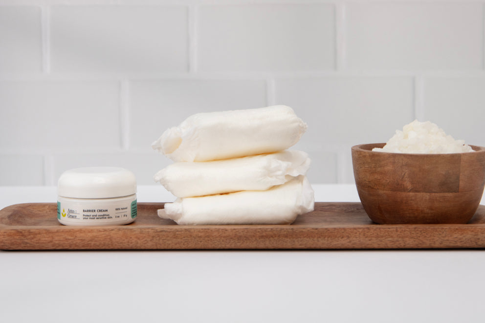 Attn: Grace barrier cream and pads lined up on a wooden serving plate