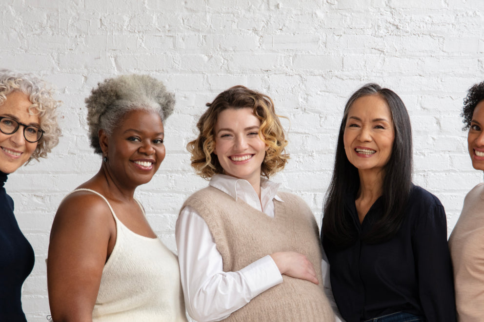 Women of different ages and stages smiling 