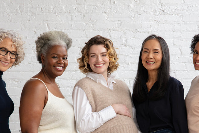 Women of different ages and stages smiling 